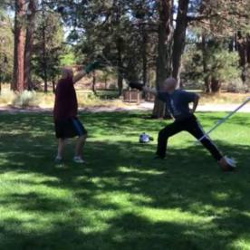 Alex Spreier of High Desert Armizare, and I demonstrating the parry of fifth against a cut to the head