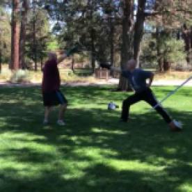 Alex Spreier of High Desert Armizare, and I demonstrating the parry of fifth against a cut to the head